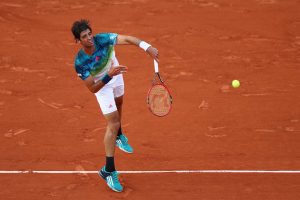 PARIS, FRANCE - MAY 23: Thomaz Bellucci of Brazil serves during the Men's Singles first round match against Richard Gasquet of France on day two of the 2016 French Open at Roland Garros on May 23, 2016 in Paris, France. (Photo by Julian Finney/Getty Images)